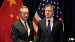 US Secretary of State Blinken shakes hands with Director of the Office of the Foreign Affairs Commission of the Communist Party of China's Central Committee Wang Yi during their meeting in Jakarta, July 13, 2023. (Photo by Dita Alangkara / Pool / AFP)