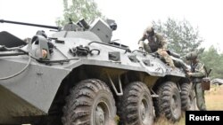 A Wagner fighter and a Belarusian service member take part in a joint training at the Brest military range outside Brest, Belarus,