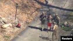 FBI agents arrest Jack Teixeira, an employee of the U.S. Air Force National Guard, outside a residence in this still image taken from video in North Dighton, Massachusetts, April 13, 2023. (WCVB-TV via ABC via Reuters)