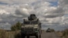 Ukrainian armored military vehicles drive from the direction of the border with Russia, in the Sumy region, on Aug. 13, 2024.