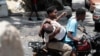 People take a man who was shot in the head during violent gang clashes, to a hospital in the Carrefour-Feuilles district of Port-au-Prince, Haiti, Aug. 15, 2023.