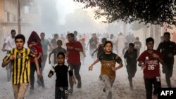 Palestinian children run as they flee from Israeli bombardment in Rafah in the southern Gaza Strip on Nov. 6, 2023.