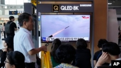 A TV screen shows a file image of North Korea's missile launch during a news program at the Seoul Railway Station in Seoul, South Korea, July 22, 2023.