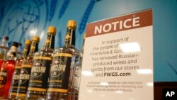 FILE - A sign in the vodka area of a Pennsylvania Fine Wine and Good Spirits store reflects the state's decision to withdraw Russian-made products for sale, in Harmony, Pa., Feb. 28, 2022.