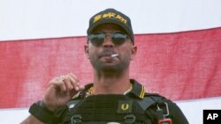 FILE - Proud Boys leader Henry "Enrique" Tarrio wears a hat that says The War Boys during a rally in Portland, Ore., on Sept. 26, 2020.