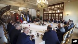 Delegations meet along with United Nation observers, right, and Turkish Defence Ministry members in Istanbul, Turkey, Wednesday