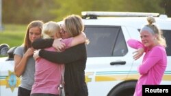 People console each other after a shooting outside Cornerstone Church in Ames, Iowa, June 2, 2022. (Nirmalendu Majumdar/USA Today Network via Reuters)