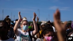 FILE - Anti-government protesters rally against ongoing food shortages and high prices for foodstuff, at the Maximo Gomez monument in Havana, Cuba, July 11, 2021.