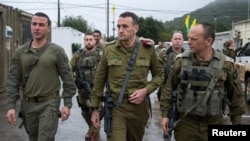 Chief of the General Staff of the Israel Defense Forces Herzi Halevi walks along with other officials, during what the Israeli military says was a visit to Al Shifa hospital, in a place given as Gaza