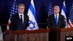 Israeli Prime Minister Benjamin Netanyahu (R) looks on as US Secretary of State Antony Blinken gives statements to the media inside The Kirya, which houses the Israeli Defence Ministry, after their meeting in Tel Aviv on October 12, 2023.