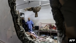 (FILES) People inspect the damage in a room following Israeli bombardment at Nasser hospital in Khan Yunis in the southern Gaza Strip on December 17, 2023, amid ongoing battles between Israel and the Palestinian militant group Hamas.