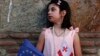 A Georgian girl holds an EU and Georgian national flags as she watches a concert marking the signing of the association with EU agreement in Tbilisi, Georgia, Friday, June 27, 2014. The European Union signed similar association agreements with two other f