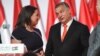 (FILES) Reelected chairman of the governing FIDESZ party, Hungarian Prime Minister Viktor Orban, reacts on the podium beside then elected party deputy-chairman, Hungarian Minister of State for Family and Youth Affairs Katalin Novak (L), during the party c