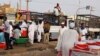 People gather to ride trucks as they flee during clashes between the paramilitary Rapid Support Forces and the army in Khartoum North