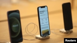 FILE PHOTO: IPhone 12 phones are seen at the new Apple Store on Broadway in downtown Los Angeles