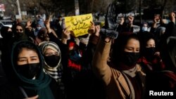 Afghan women chant slogans in protest against the closure of universities to women by the Taliban in Kabul