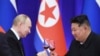 TOPSHOT - In this pool photograph distributed by the Russian state agency Sputnik, Russian President Vladimir Putin and North Korean leader Kim Jong Un toast during a reception at the Mongnangwan Reception House in Pyongyang on June 19, 2024.