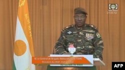 This video frame grab image obtained by AFP from ORTN - Télé Sahel on August 19, 2023 shows Niger's new military ruler General Abdourahamane Tiani, reading a statement on national television.