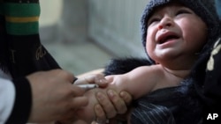 FILE - A child receives a measles vaccine at the Indira Gandhi Children Hospital, in Kabul, Afghanistan, March 15, 2021.