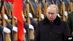 Russian President Vladimir Putin attends a wreath-laying ceremony at the Tomb of the Unknown Soldier, near the Kremlin Wall during the national celebrations of the 'Defender of the Fatherland Day' in Moscow, Feb. 23, 2022.