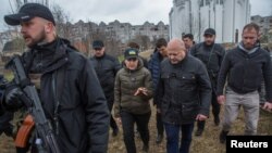 International Criminal Court Prosecutor Khan and Ukraine's Prosecutor General Venediktova visit a site of a mass grave in the town of Bucha